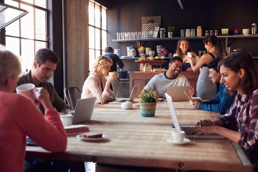 People meeting and sitting around a wooden table